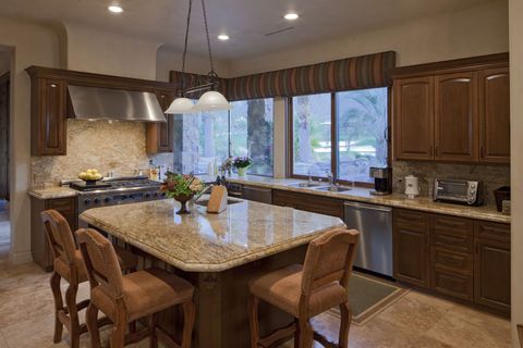 A kitchen with granite counter tops and stainless steel appliances