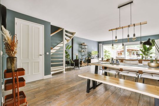 A dining room with a long table and benches