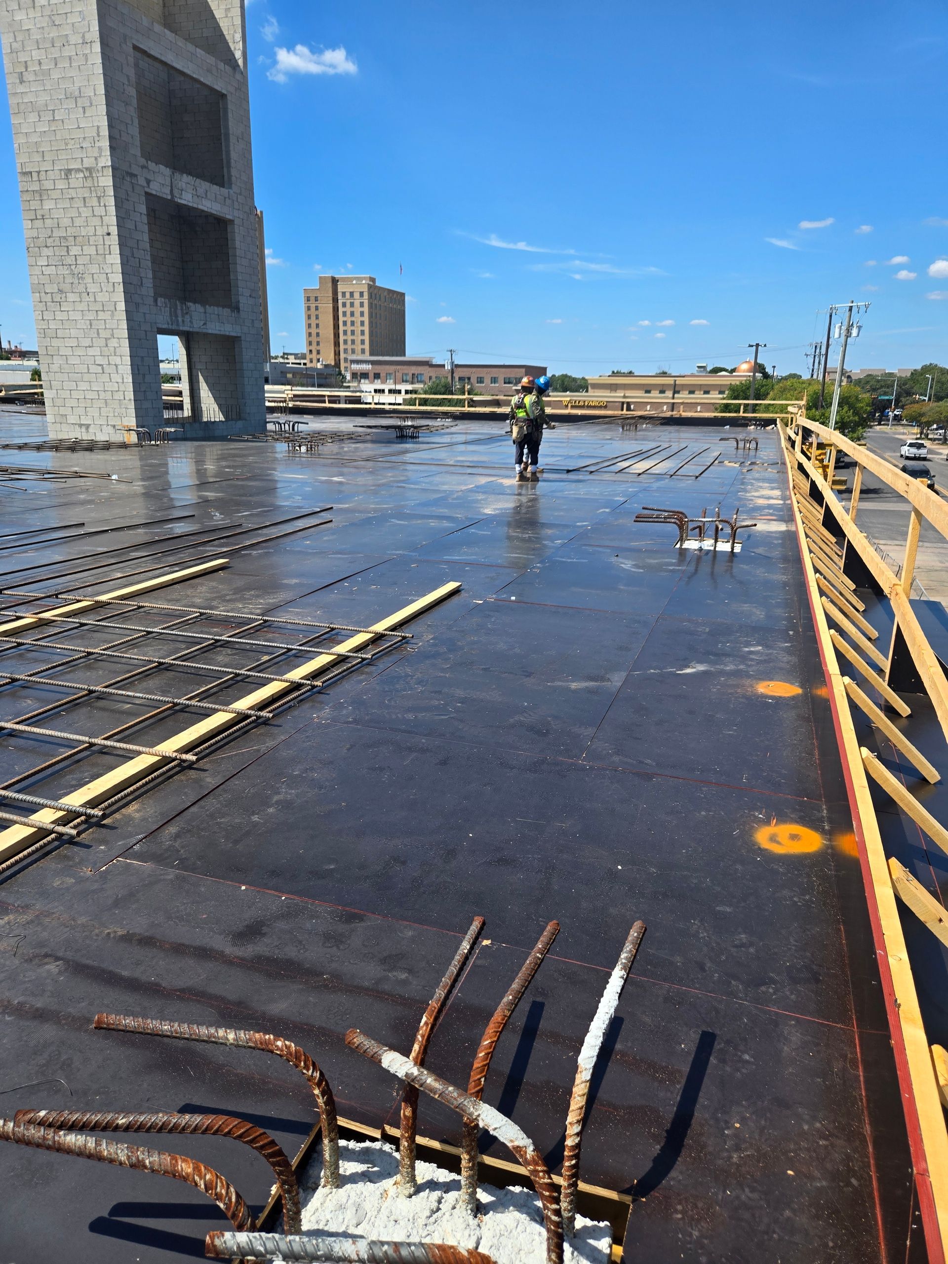 A construction site with a bridge in the background.