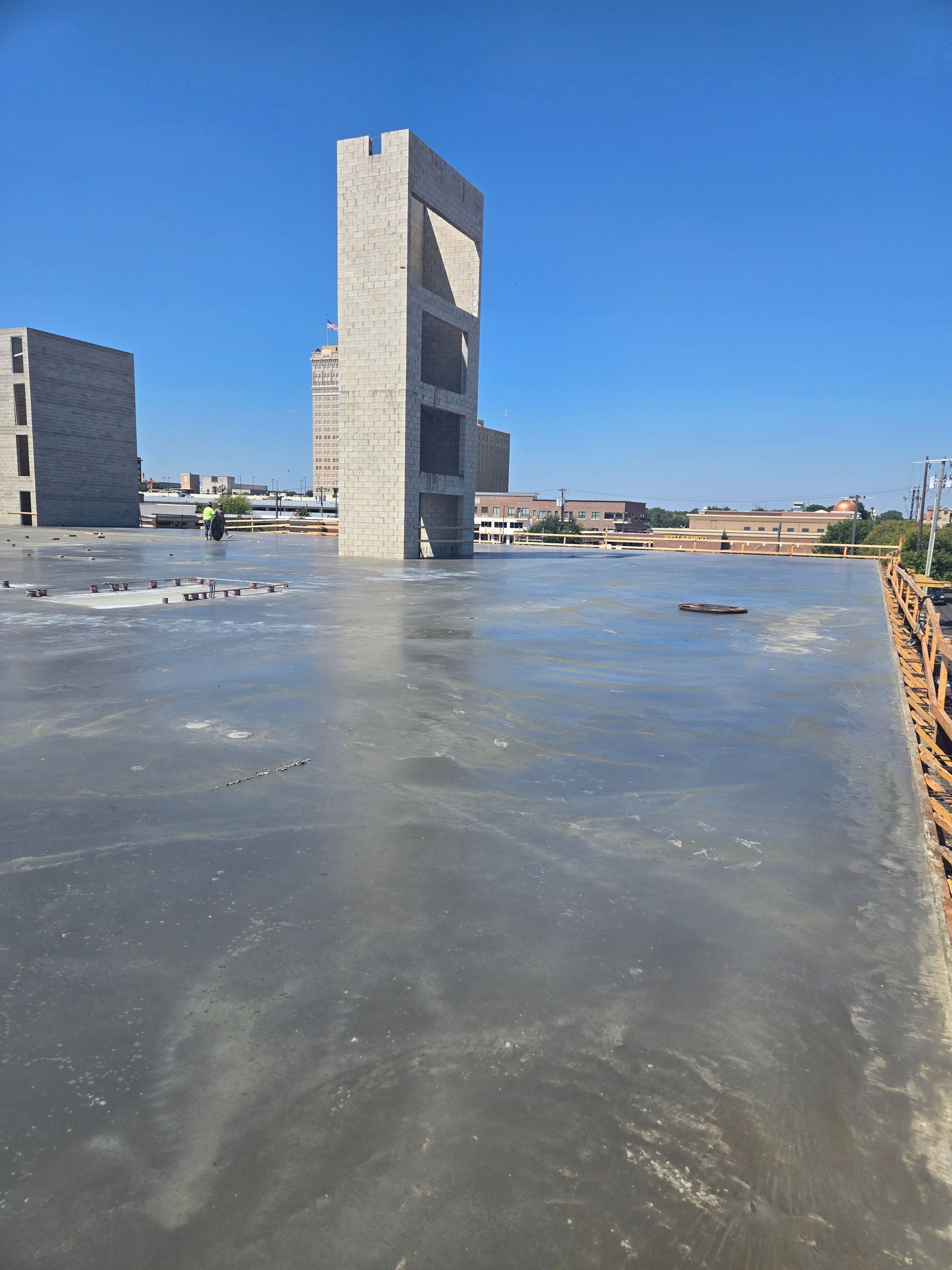 A concrete floor with a building in the background