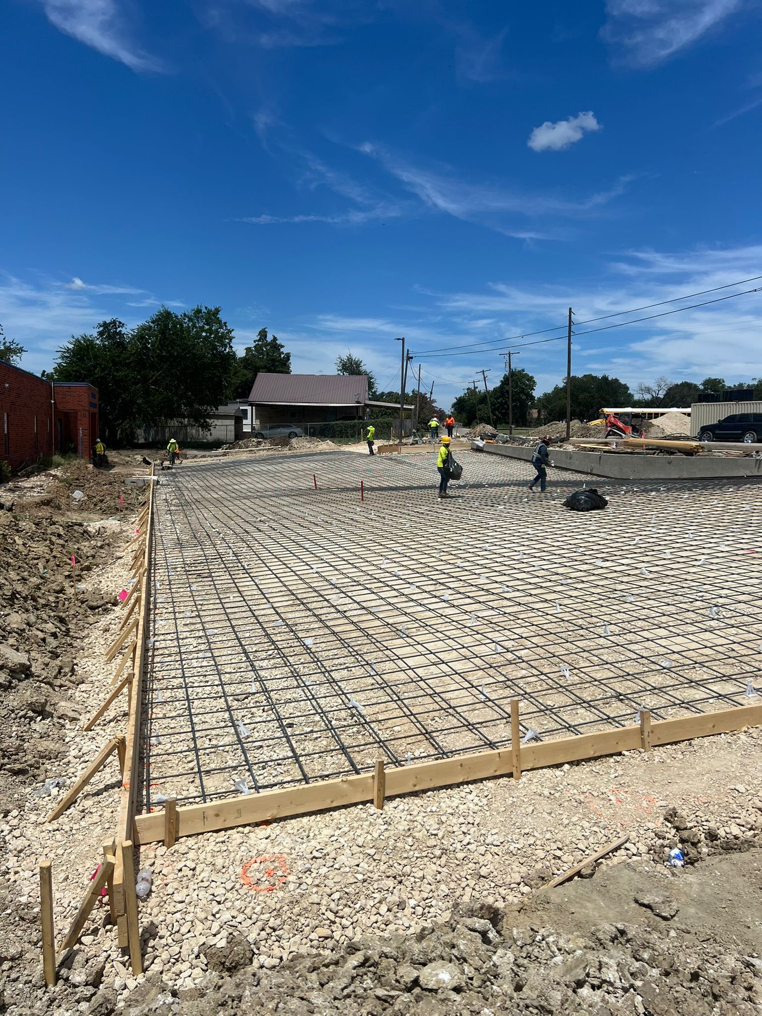 A construction site with a lot of gravel and a blue sky in the background.