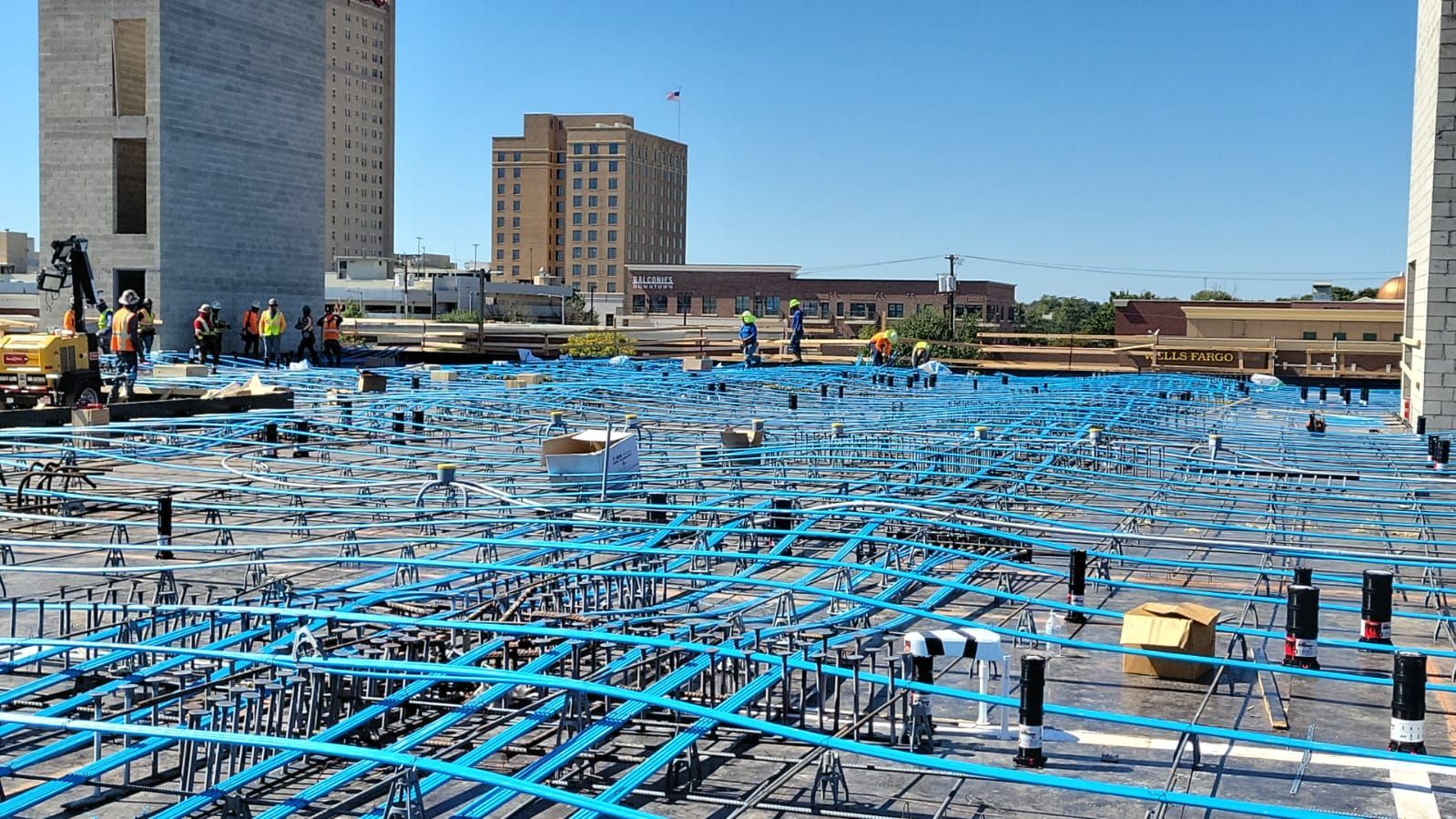 A construction site with a lot of blue tape on the ground.