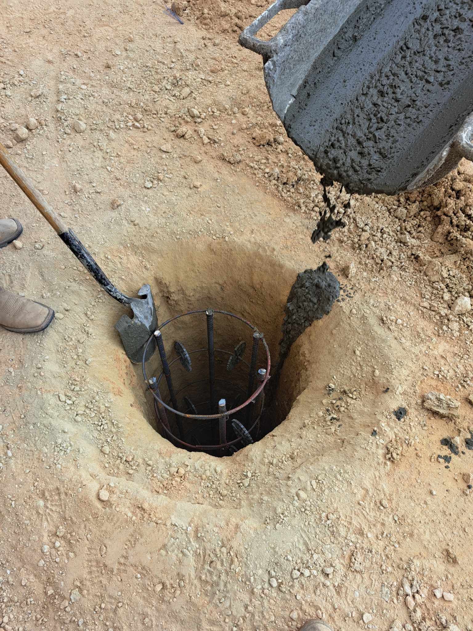 A person is digging a hole in the ground with a shovel.