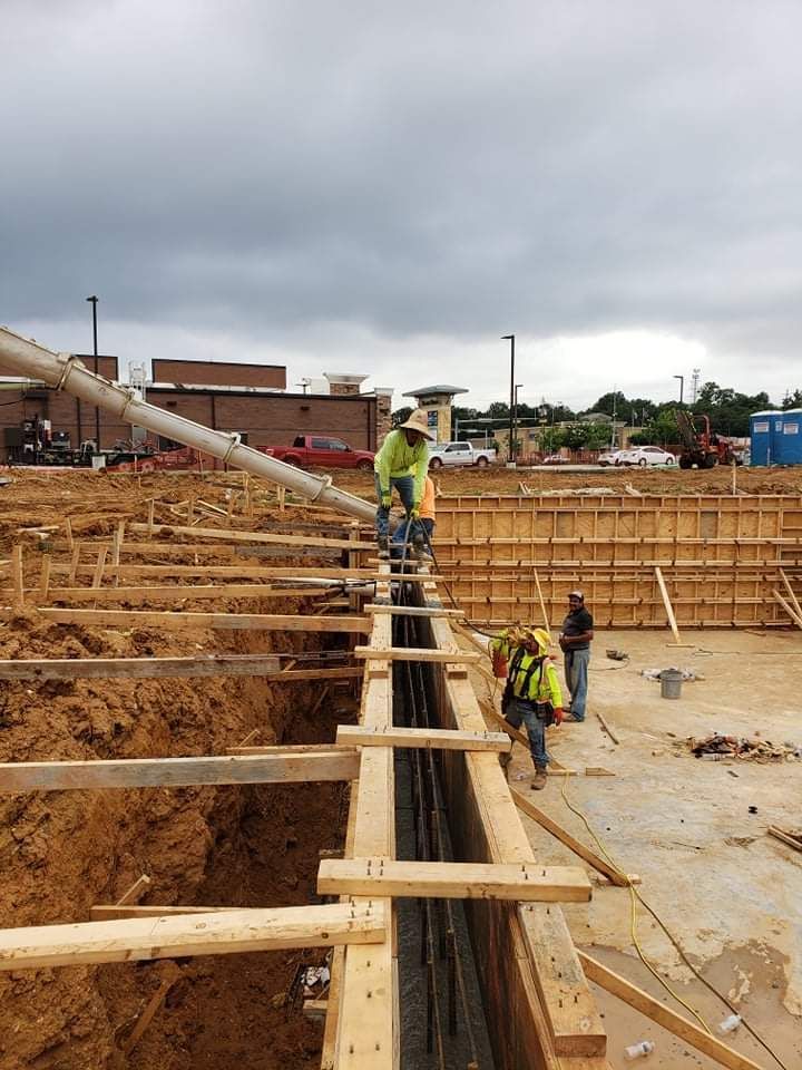 A group of construction workers are working on a construction site.