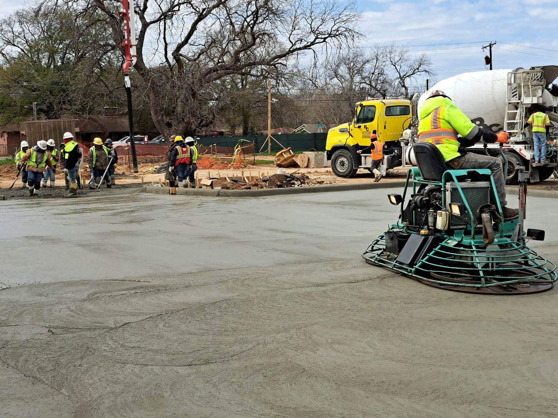 A group of construction workers are working on a road.