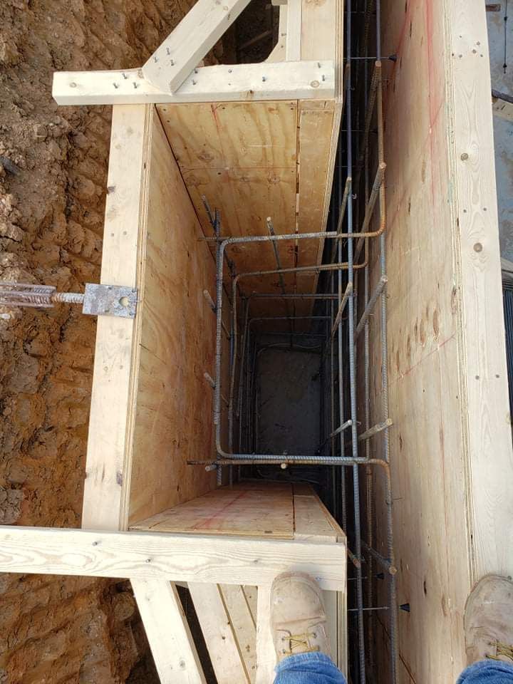 A person is standing in a hole in a wooden box.