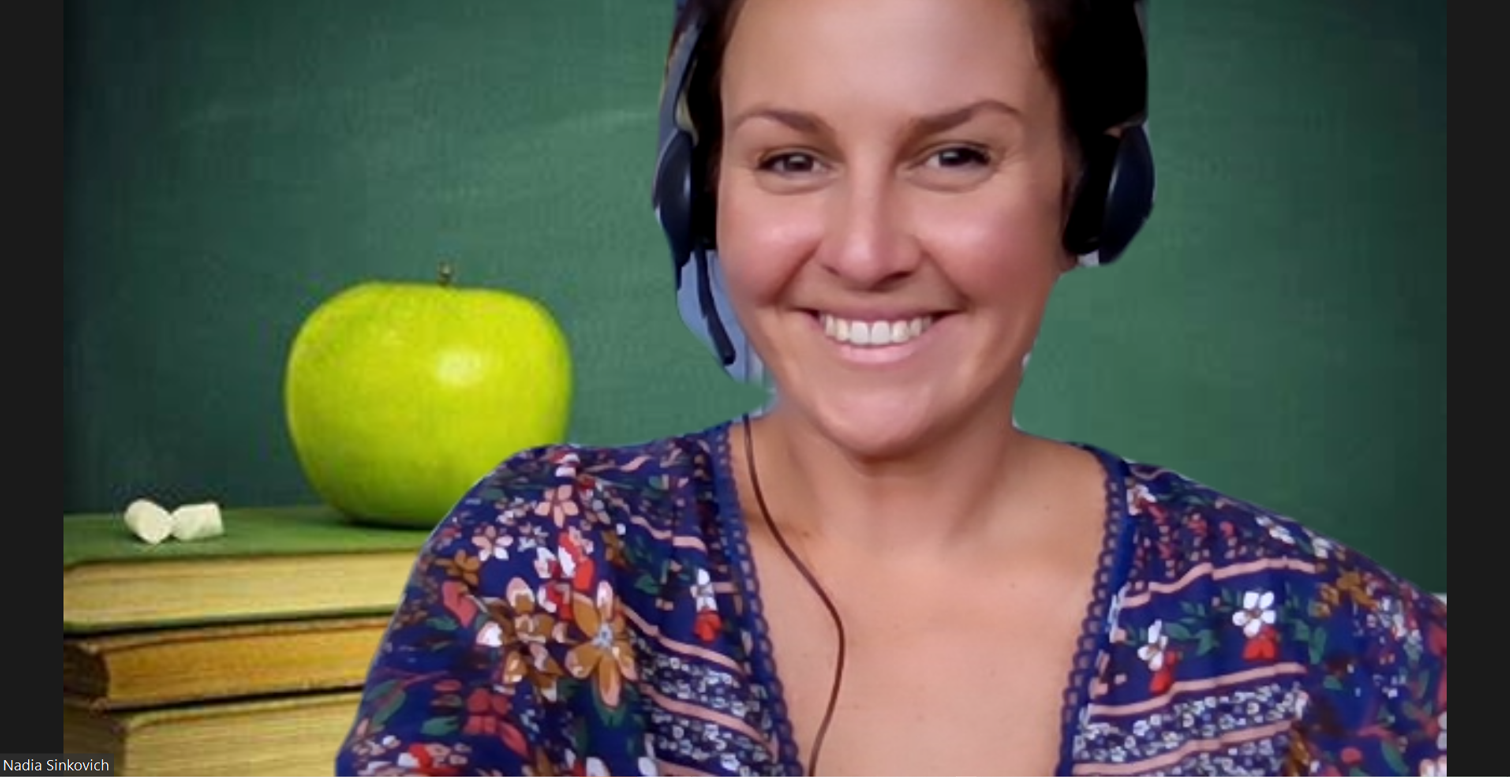 a woman wearing headphones is smiling in front of a green apple .