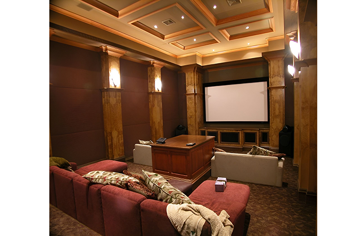 A home theater with a couch and a projector screen