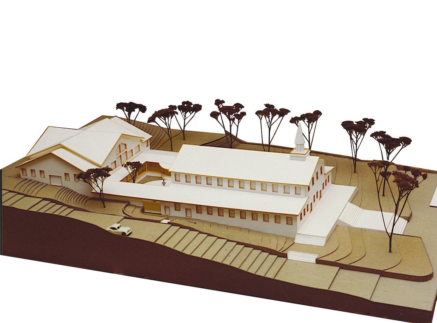 A model of a building with trees in the background