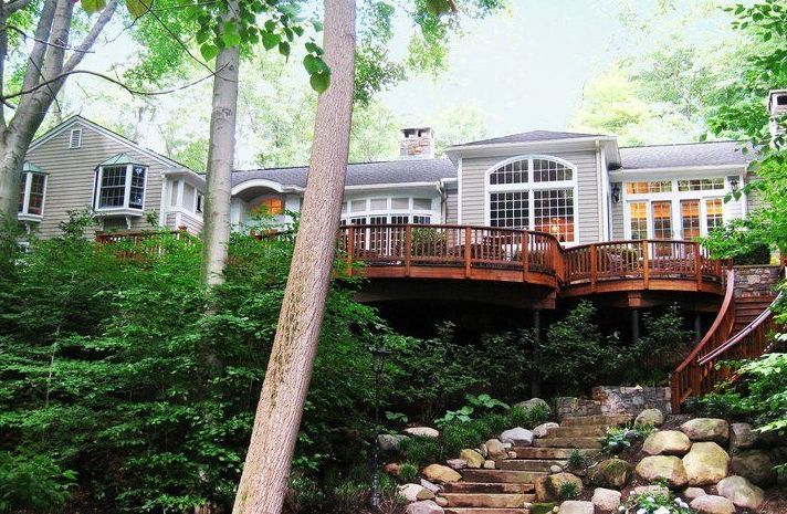 A house with a large deck and stairs leading up to it