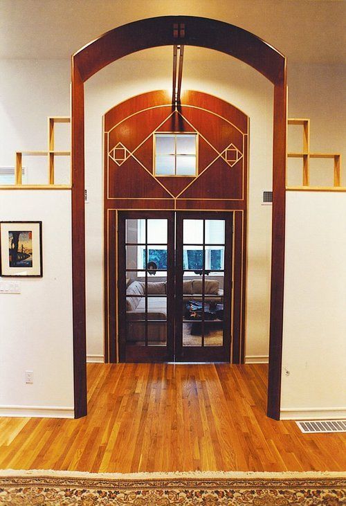 A room with a wooden floor and arched doorway