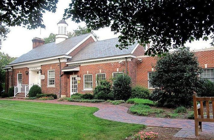 A brick building with a bench in front of it