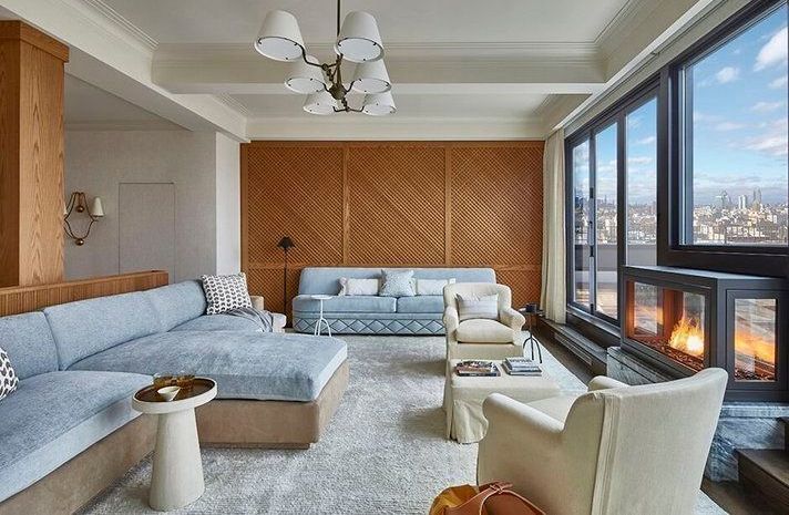 A living room with a couch , chairs , and a fireplace.