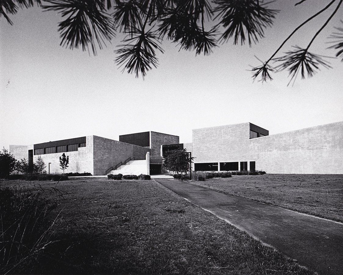 A black and white photo of a large building with stairs