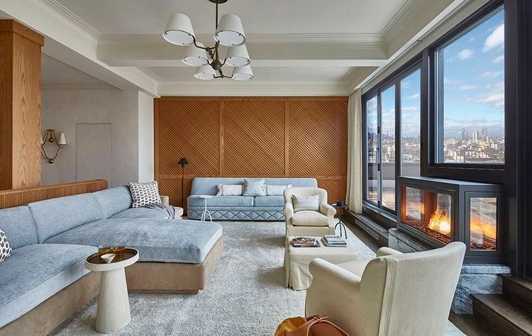 A living room with a couch , chairs , and a fireplace.