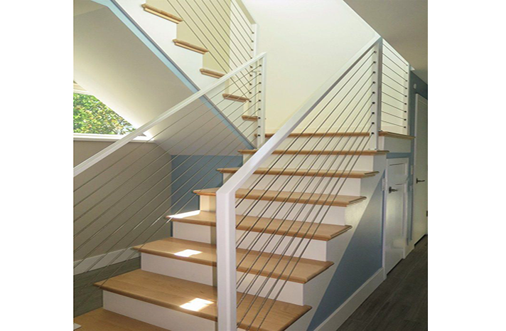 A staircase with wooden steps and a white railing