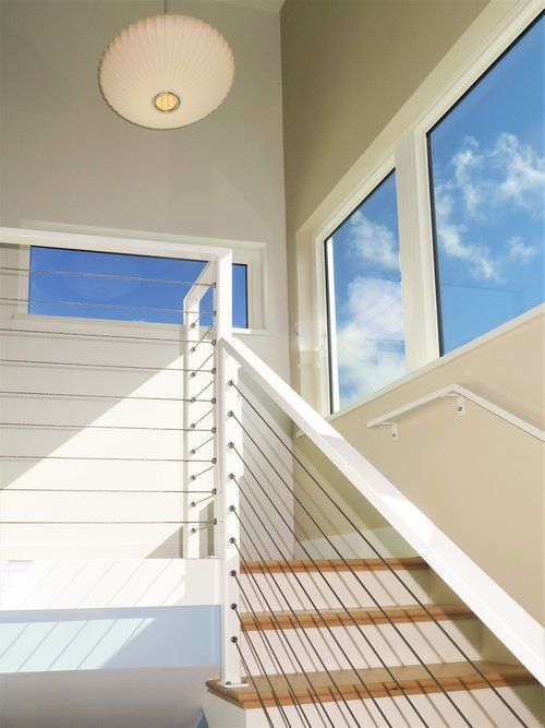 A white staircase with wooden steps and a white railing