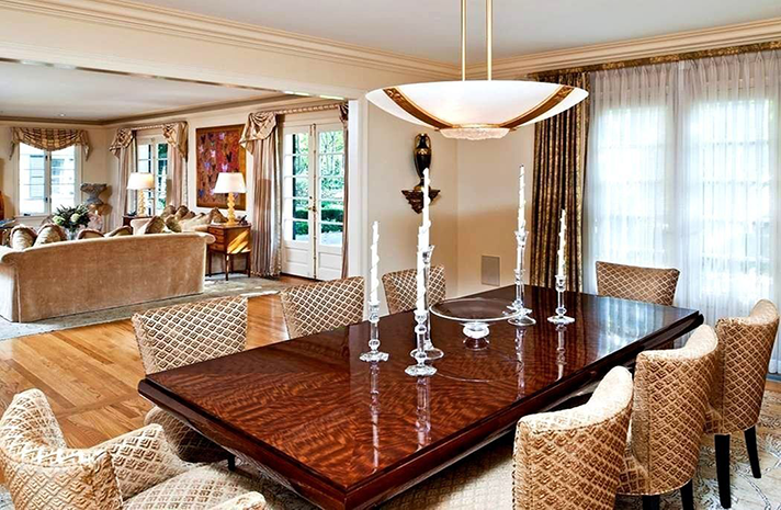 A dining room with a long table and chairs