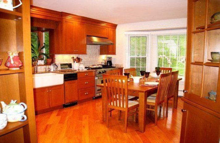 A kitchen with a table and chairs and a sink