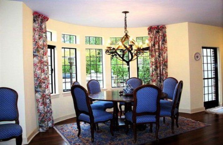 A dining room with a table and chairs and a chandelier