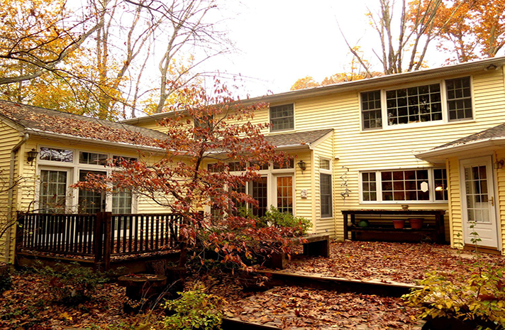 A large house with a deck and a lot of windows