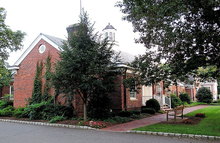 A brick building with a clock on the top of it