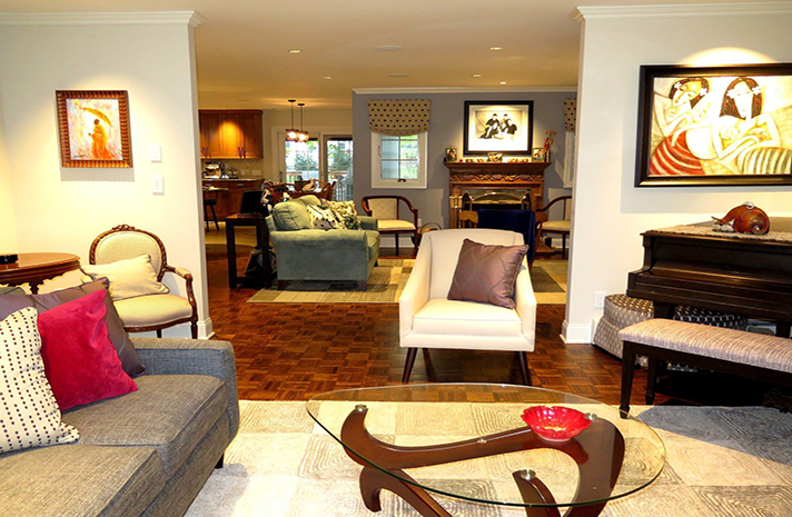 A living room with a couch and chairs and a glass coffee table
