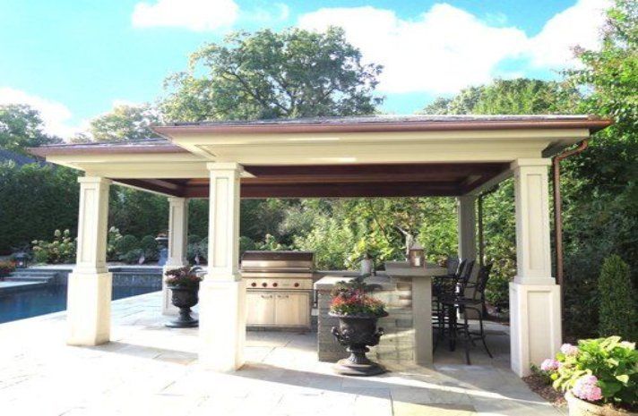 A gazebo with a grill and a table underneath it