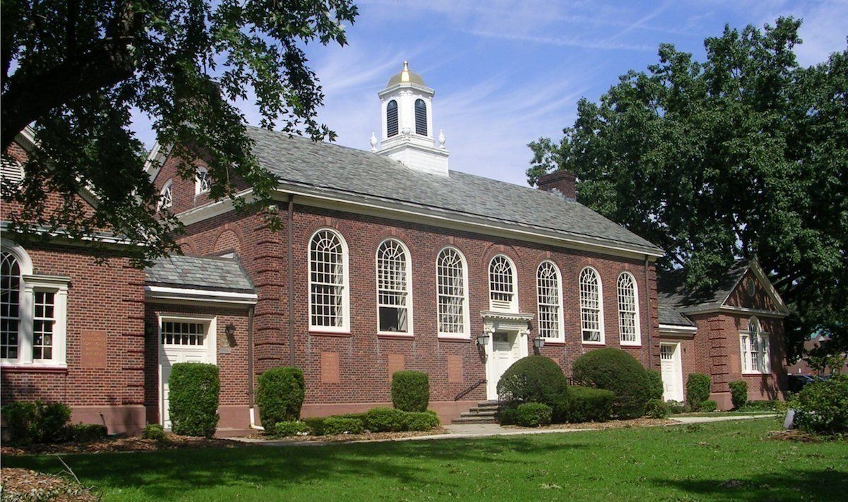 A large brick building with a steeple on top of it