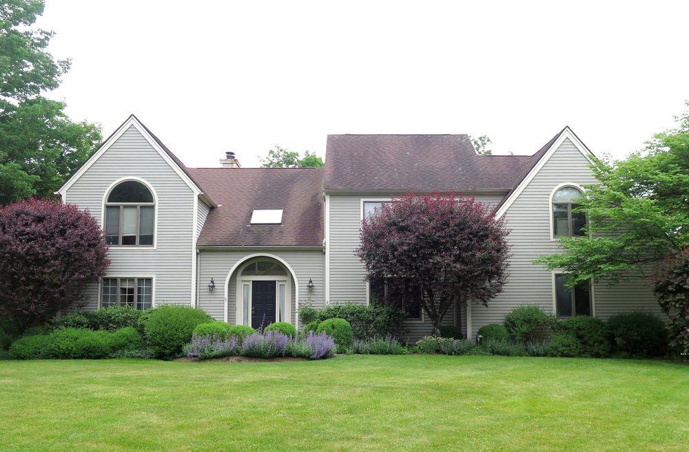 A large house with a large lawn in front of it