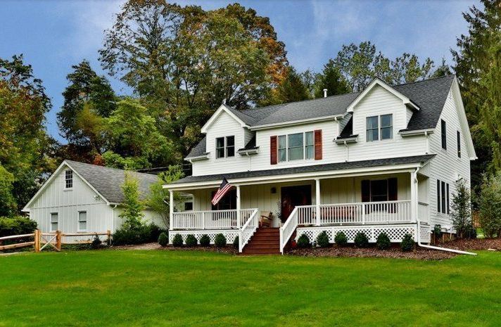 A large white house with a large porch