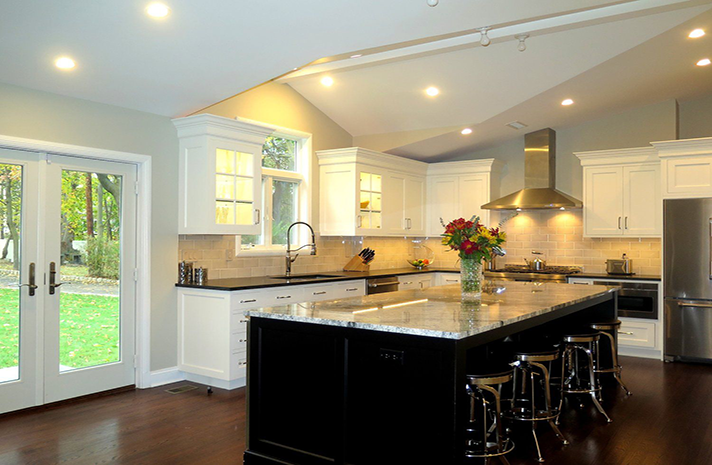 A kitchen with a large island and stools