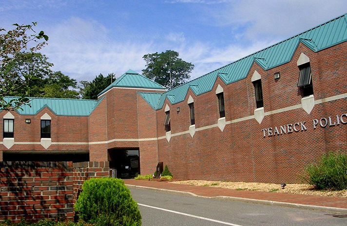 A brick building with a green roof that says franklin police
