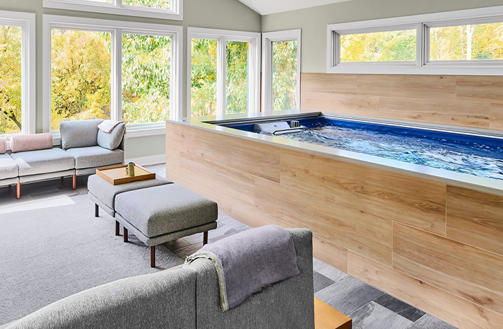 A living room with a swimming pool in the middle of it.