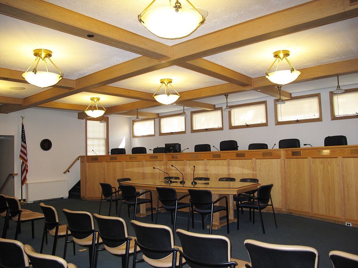 A conference room with a table and chairs in it