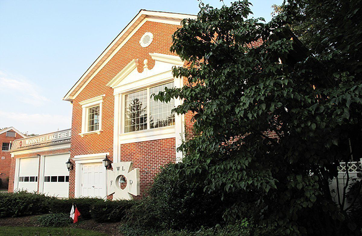 A large red brick building with a white garage door