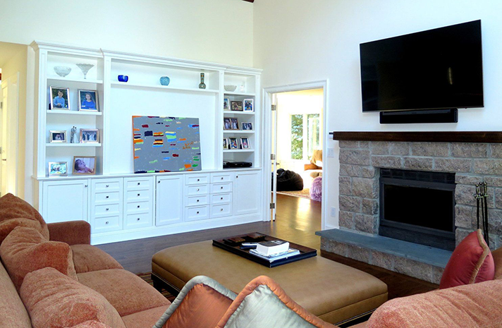 A living room with a fireplace and a flat screen tv