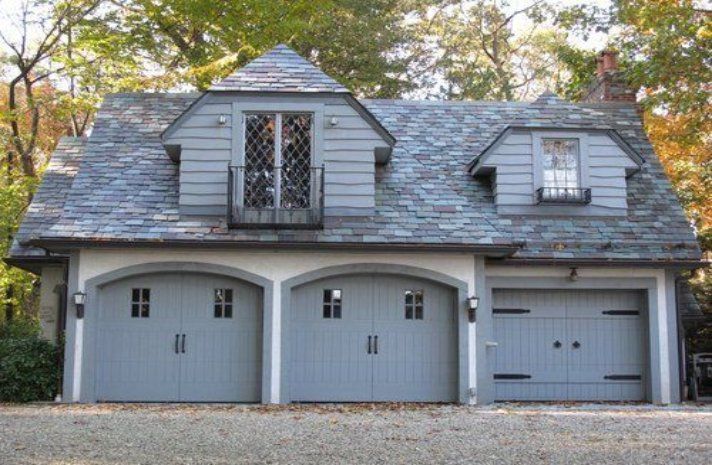 A garage with a balcony on the top of it