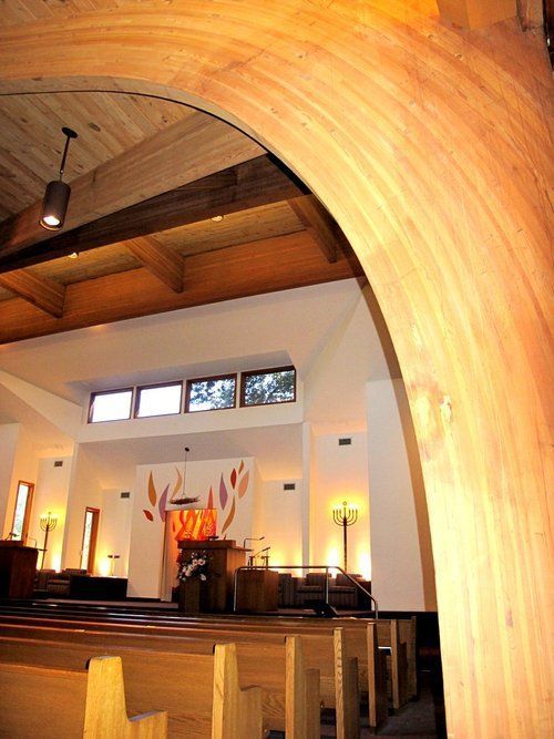 The inside of a church with a wooden archway