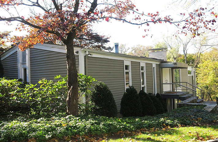 A house with a tree in front of it