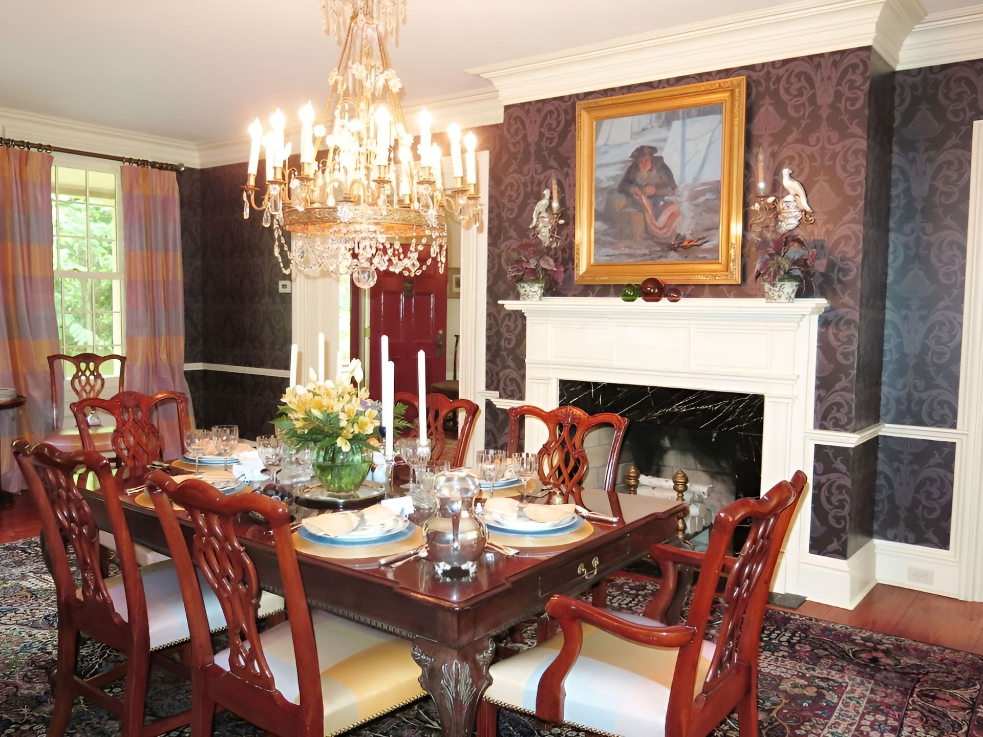 A dining room with a table and chairs and a fireplace