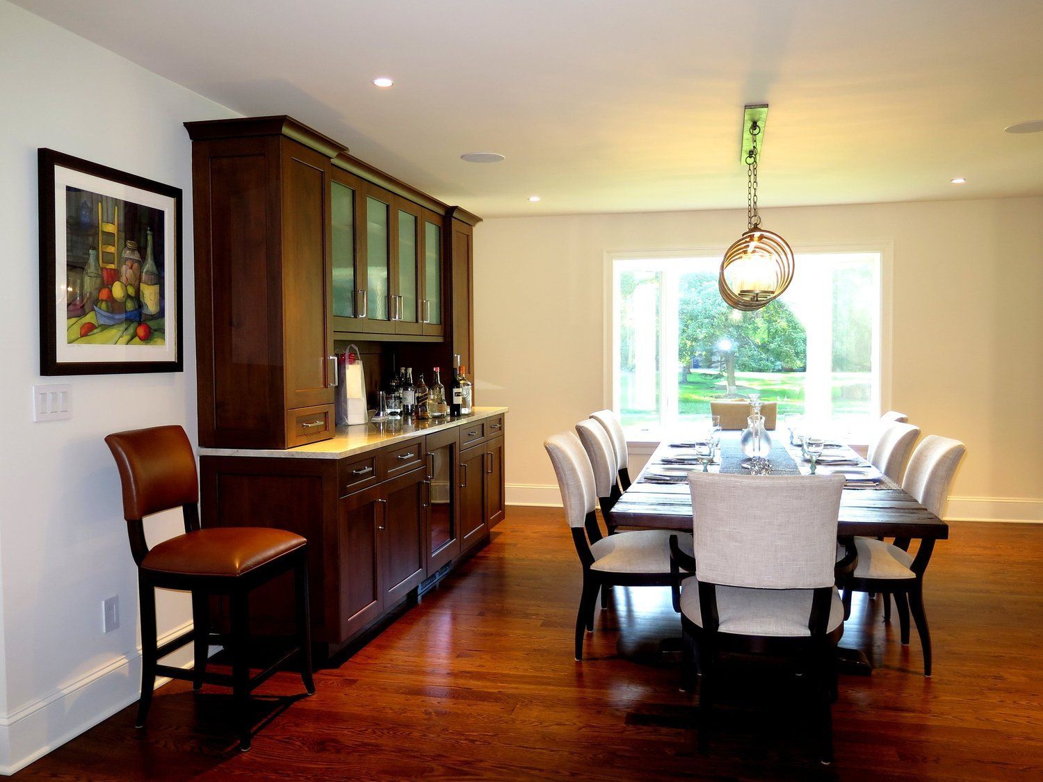 A dining room with a long table and chairs