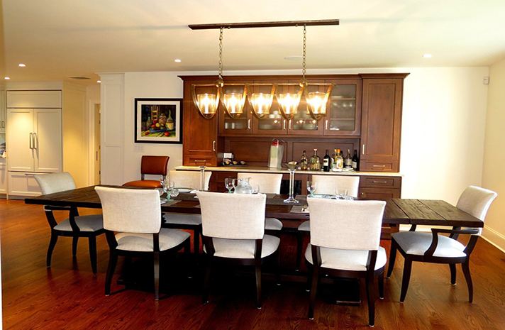 A dining room with a long table and chairs