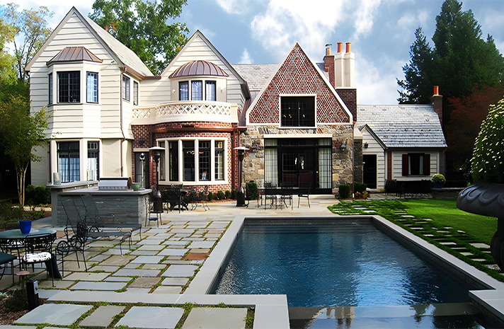 A large house with a large swimming pool in front of it