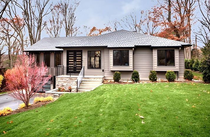 A house with a lush green lawn in front of it