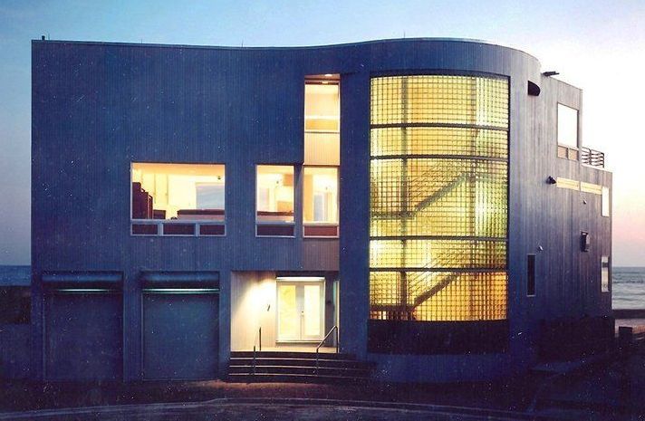 A large building with a lot of windows is lit up at night
