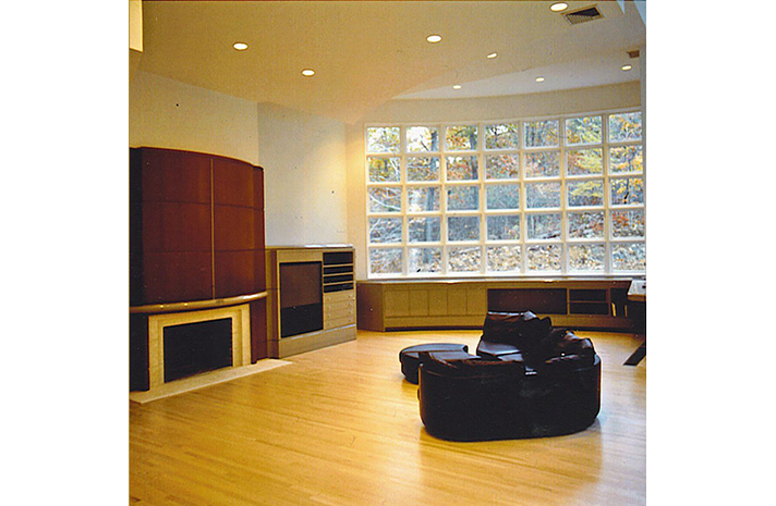 A living room with a fireplace and lots of windows