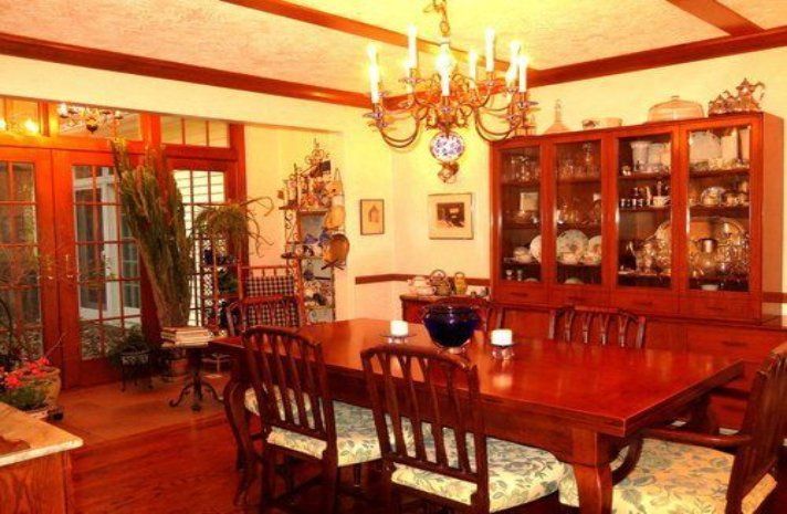 A dining room with a table and chairs and a chandelier