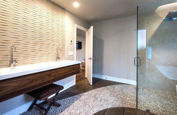 A bathroom with two sinks and a walk in shower.