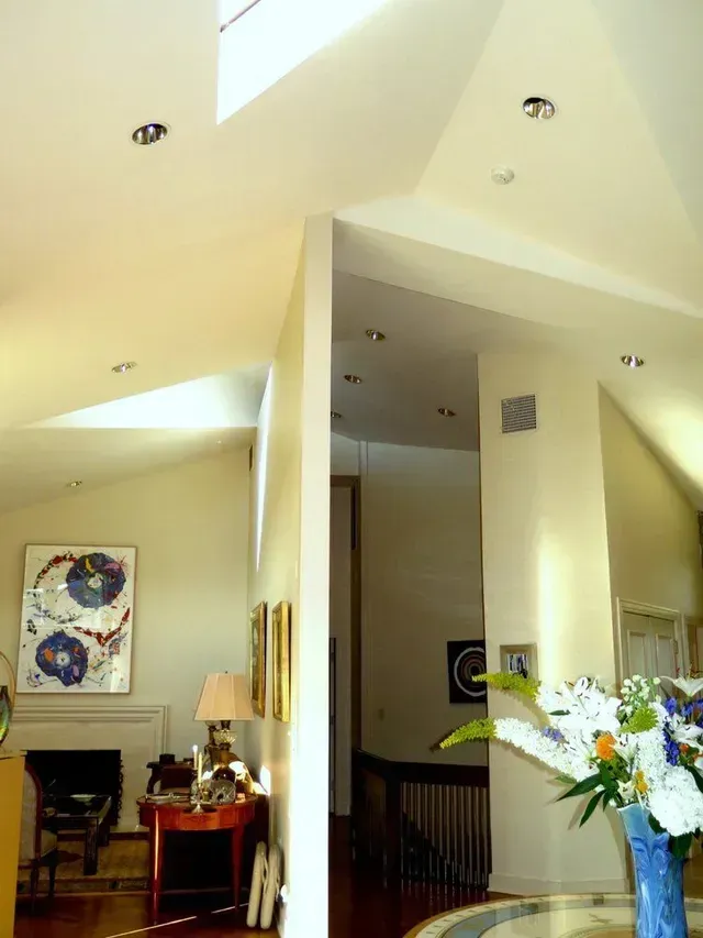 A vase of flowers sits on a table in a living room